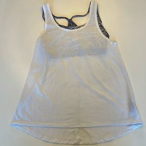 Sports shirt with built in sports bra…has been worn. Has a few marks on the back